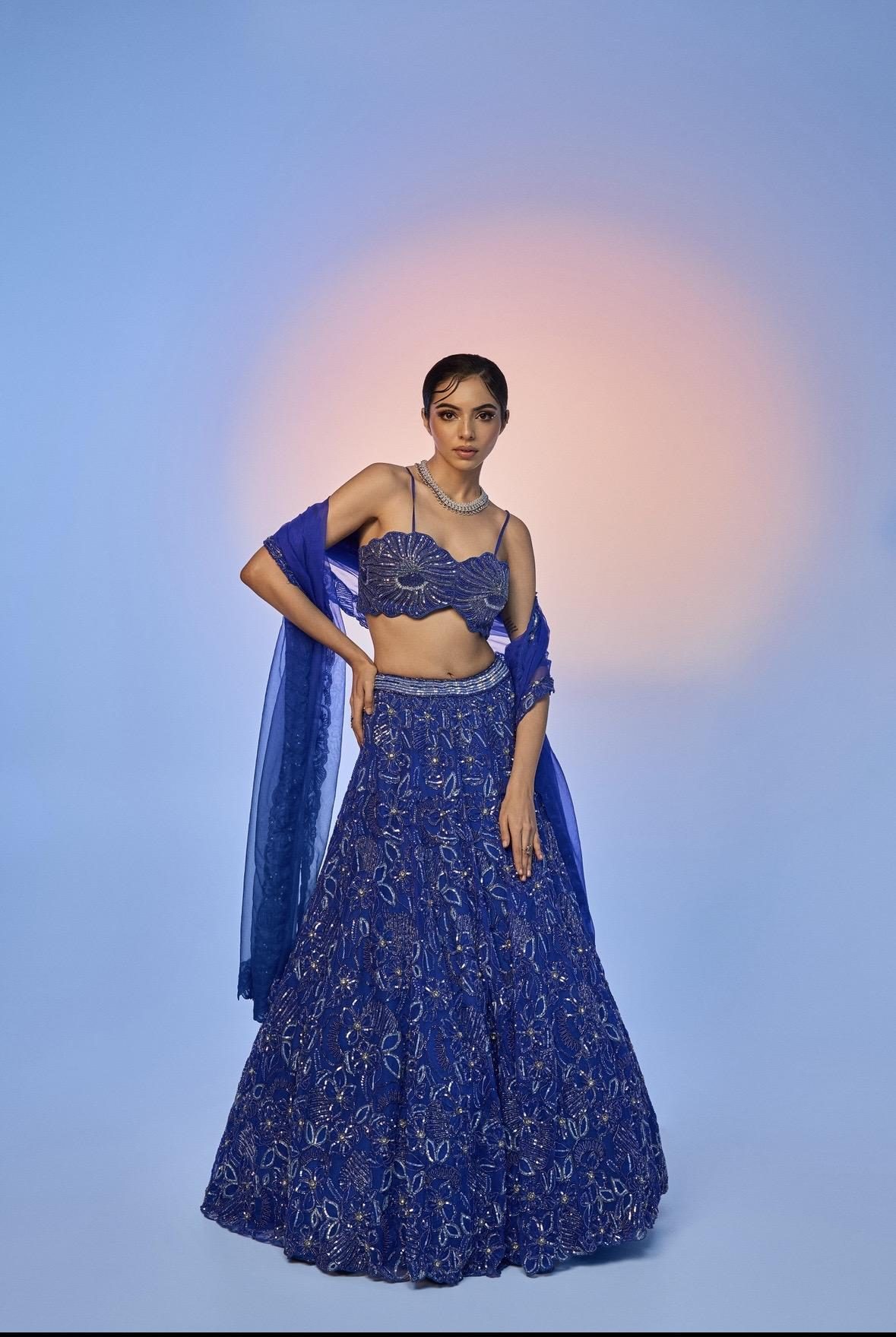 Sea Side Whispers lookbook — Electric Blue Mystique, Tidal Drama: An electric-blue abstract bustier with a diamond-studded, hand-embroidered lehenga and dupatta.