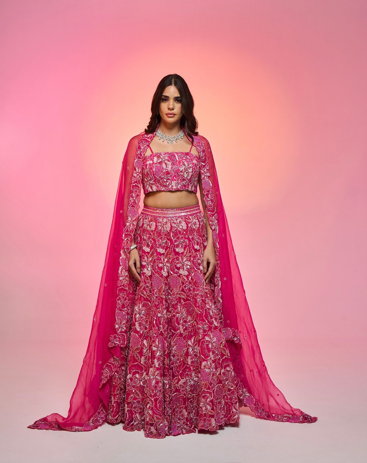 Sea Side Whispers lookbook — Rani Pink Magic of the Sea, Coral Enchantment: A magical rani-coral blouse with a diamond-studded, hand-embroidered lehenga and dupatta set.